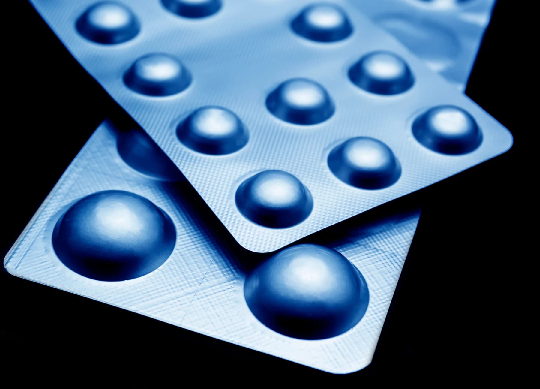 Blue-lit silver medicine blister packaging